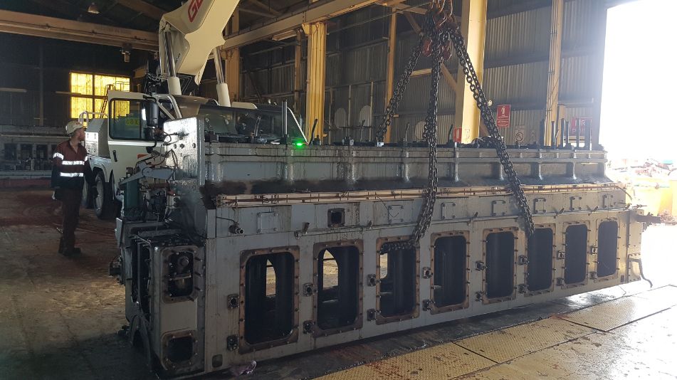 Close-up image of a Focus Demolition crew member and equipment inside the Broome Power Station.