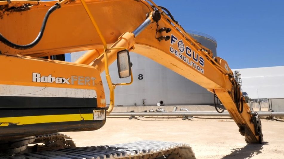 Yellow excavator with logo for Focus Demolition, Perth's leading commercial and industrial demolition company